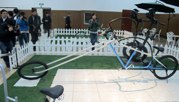 Chinese and international journalists from a media tour take photos of collections at the China Bicycle Museum in Bazhou, Hebei province, on Sunday. [Photo / China Daily]