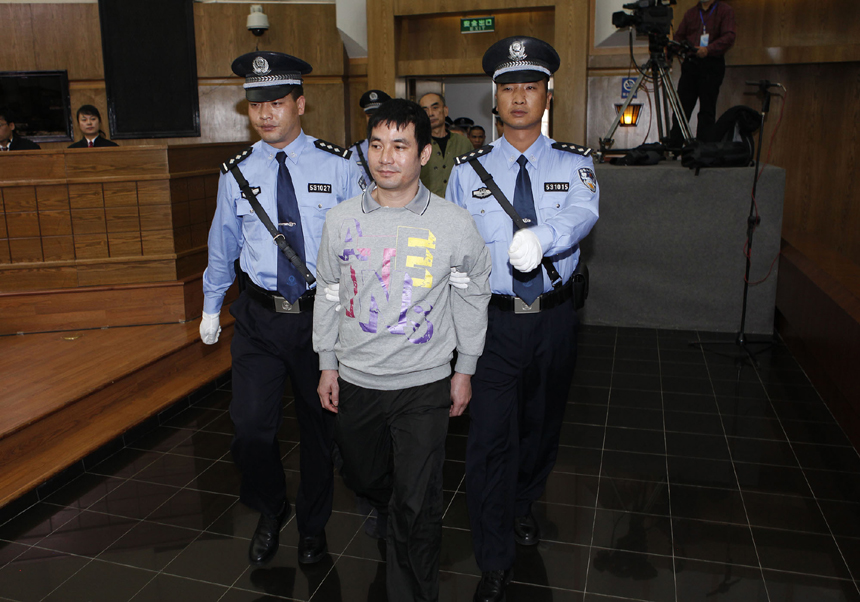 Naw Kham (C, front), principal suspect accused in the Mekong River murder case, is escorted to the court to hear the verdicts for him and five accomplices in Kunming, capital of southwest China&apos;s Yunnan Province, Nov. 6, 2012. Naw Kham was sentenced to death on Nov. 6. The 13 Chinese sailors were murdered after two cargo ships, the Hua Ping and Yu Xing 8, were hijacked on Oct. 5, 2011 on the Mekong River, an important waterway in Southeast Asia.