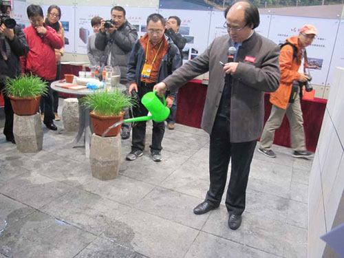 Qin Shengyi displays permeable bricks to journalists on Tuesday, November 6, 2012. [Photo/China Daily]