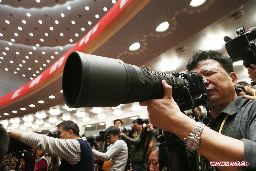 A photographer takes photos of the opening ceremony of the 18th National Congress of the Communist Party of China (CPC) at the Great Hall of the People in Beijing, capital of China, Nov. 8, 2012. The 18th CPC National Congress opened in Beijing on Thursday, which also marks the 12th Journalists&apos; Day of China. A total of 2,732 Chinese and foreign journalists are involved in the coverage of the 18th CPC National Congress. (Xinhua/Jin Liwang) 