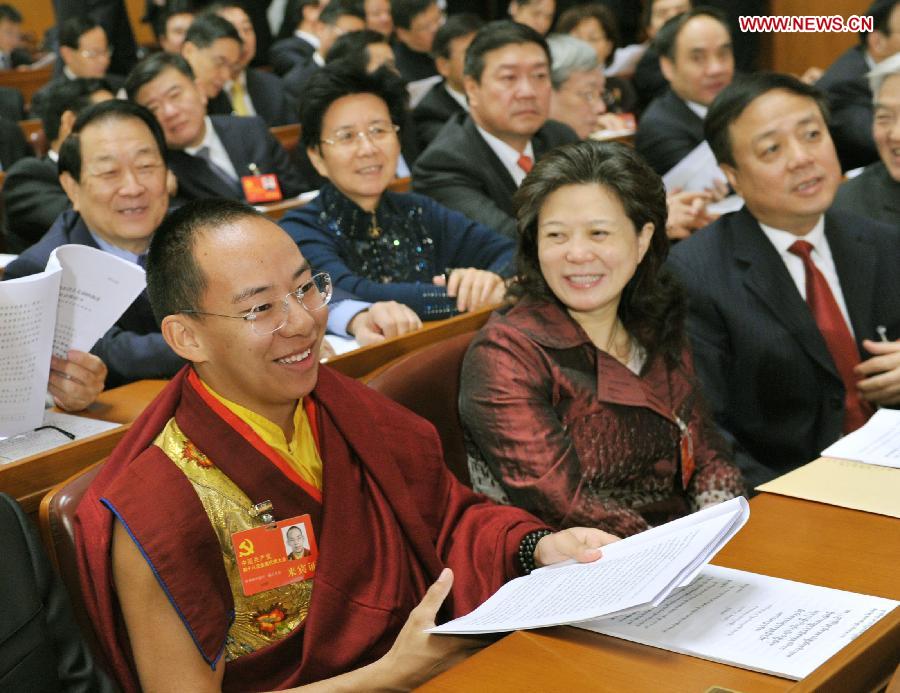The 11th Panchen Lama, Bainqen Erdini Qoigyijabu (L), attends, as a nonvoting delegate, the opening ceremony of the 18th National Congress of the Communist Party of China (CPC) at the Great Hall of the People in Beijing, capital of China, on Nov. 8, 2012. The 18th CPC National Congress opened in Beijing on Thursday. (Xinhua/Huang Jingwen) 