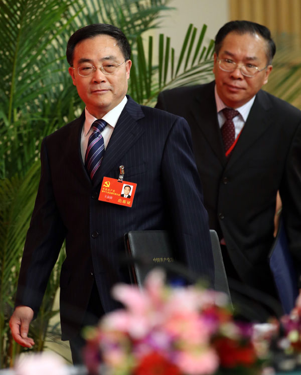 Wang Jingqing, vice-minister of the Organization Department of the Communist Party of China Central Committee, arrives on Friday for the first news conference since the opening of the 18th CPC National Congress in Beijing. Behind him is Wang Guoqing, vice-minister of the International Communication Office of the CPC Central Committee. [Photo / China Daily]
