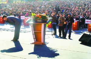 At the Yongledian public square, on the southeast outskirts of Beijing, Ding Jianhua delivers his annual work report to about 5,000 villagers sitting on stools on Oct. 31.
