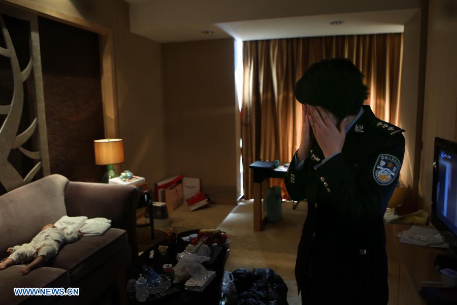 Jiang Min, a delegate to the 18th National Congress of the Communist Party of China (CPC), is seen at her hotel room with her baby in Beijing, capital of China, Nov. 13, 2012. 