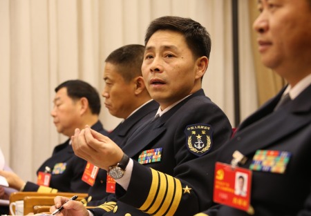 Mei Wen (second from right), senior colonel and political commissar of China's first aircraft carrier the Liaoning, speaks during the group discussion of the 18th CPC National Congress. [Xinhua photo]