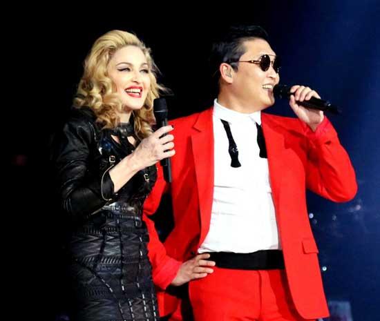 In this Nov. 13, 2012 photo released by Guy Oseary, singer Madonna, left, is shown onstage with South Korean rapper PSY during Madonna's MDNA concert at Madison Square Garden in New York. 