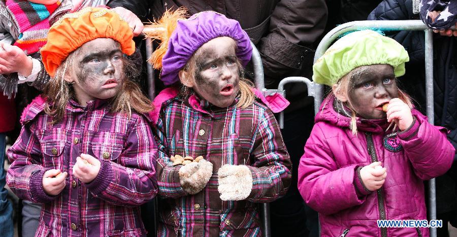 Children dressed up as Zwarte Piet, companion of Sinterklass, the character of Santa Claus, attend a celebration to welcome Sinterklass in Roermond, the Netherlands, Nov. 17, 2012. 