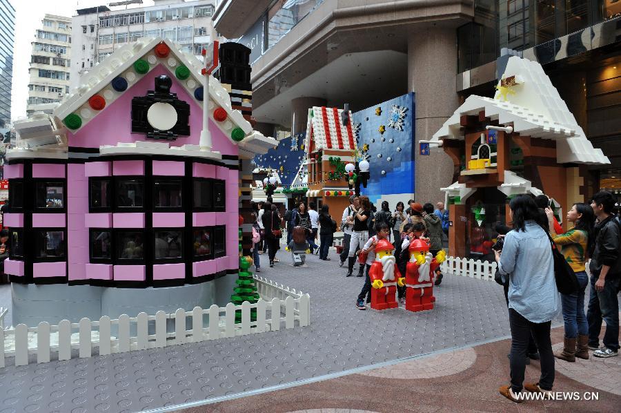 People visit the 'Christmas village' built with building blocks at the Times Square in Causeway Bay in south China's Hong Kong, Nov. 16, 2012. As Christmas is drawing near, decorations have been used for creating atmosphere in Hong Kong. 