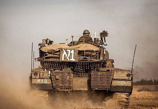 An Israeli Merkava tank is seen in a staging area on the border with the Gaza Strip in southern Israel, Nov. 16, 2012. Israel has called up thousands of soldiers and moved hundreds of military vehicles to the border to escalate the operation of 'Pillar of Defense'. [Xinhua Photo]