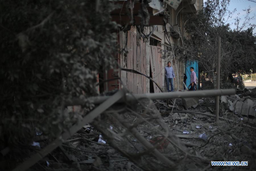 Palestinians inspect the destroyed compound of the internal security ministry in Gaza City after it was targeted by an overnight Israeli air strike on Nov. 21, 2012. 