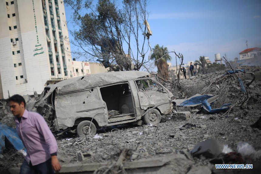 A Palestinian man inspects the destroyed compound of the internal security ministry in Gaza City after it was targeted by an overnight Israeli air strike on Nov. 21, 2012. 