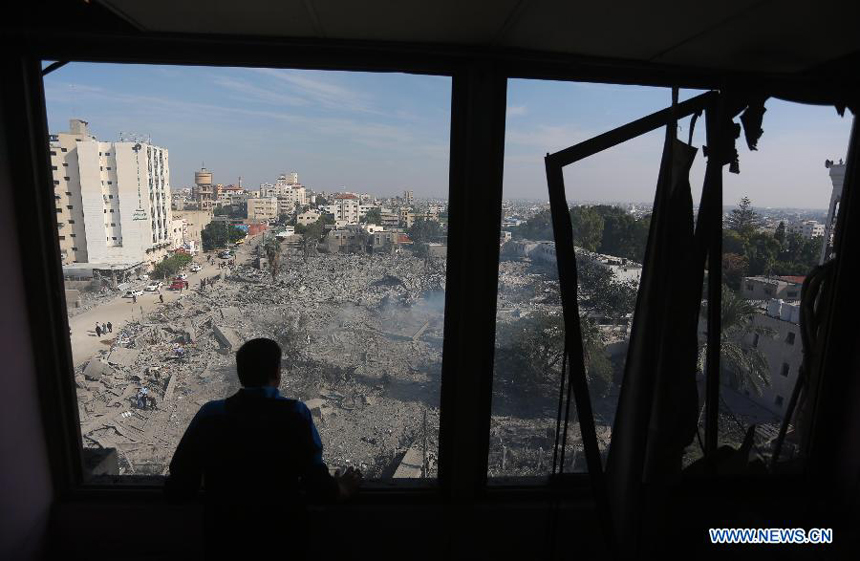 A Palestinian man inspects the destroyed compound of the internal security ministry in Gaza City after it was targeted by an overnight Israeli air strike on Nov. 21, 2012.