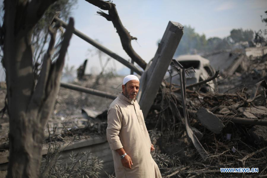 A Palestinian man inspects the destroyed compound of the internal security ministry in Gaza City after it was targeted by an overnight Israeli air strike on Nov. 21, 2012.