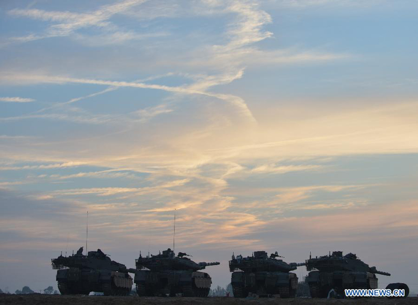 Israeli ground troops are seen stationed at an Israeli army deployment area near the Israel-Gaza Strip border on Nov. 21, 2012. The Israeli Prime Minister&apos;s Office confirmed on Wednesday evening that a ceasefire agreement has been reached with the Palestinian militant groups in Gaza. 