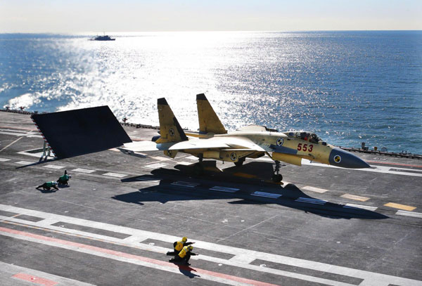 A carrier-borne J-15 fighter jet prepares to take off from China's first aircraft carrier, the Liaoning. After its delivery to the People's Liberation Army (PLA) Navy on September 25, the aircraft carrier has undergone a series of sailing and technological tests, including the flight of the carrier-borne J-15, naval sources said. Designed by and made in China, the J-15 is able to carry multi-type anti-ship, air-to-air and air-to-ground missiles, as well as precision-guided bombs. [Xinhua/Photo]