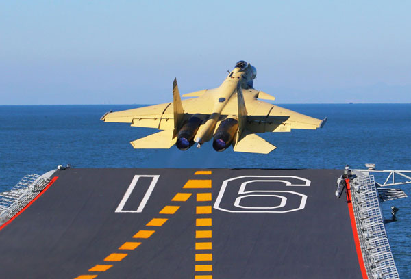  A J-15 fighter jet takes off from China's first aircraft carrier, the Liaoning. [Photo/Xinhua]