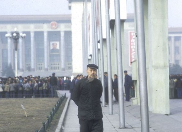 An elderly man takes a walk in Tiananmen Square.