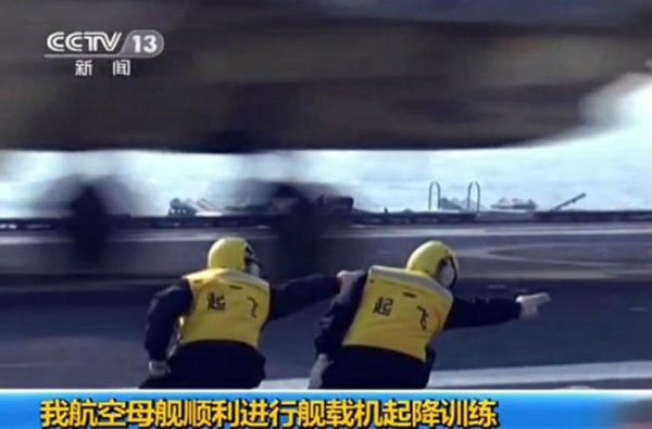 A screen capture shows commanders directing a J-15 jet taking off from and landing on China's first aircraft carrier, the Liaoning on Sunday, November 25, 2012.
