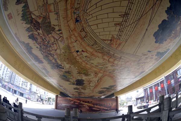 All eyes are drawn to a 30-by-10-meter replica of Along the River During the Qingming Festival - a famous ancient Chinese panoramic painting - under an overpass in the eastern city of Hangzhou, Zhejiang province, on Nov 26, 2012. 