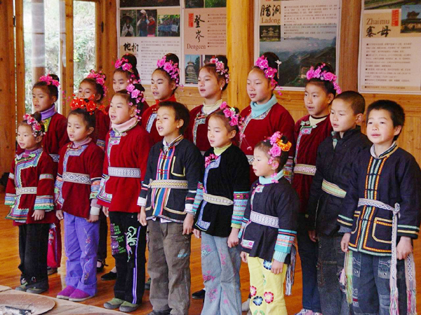 Dong students sing during a two-hour traditional singing lesson at Dimen Dong Cultural Eco-Museum, as part of the 100 Dong Songs program. [Provided to China Daily]