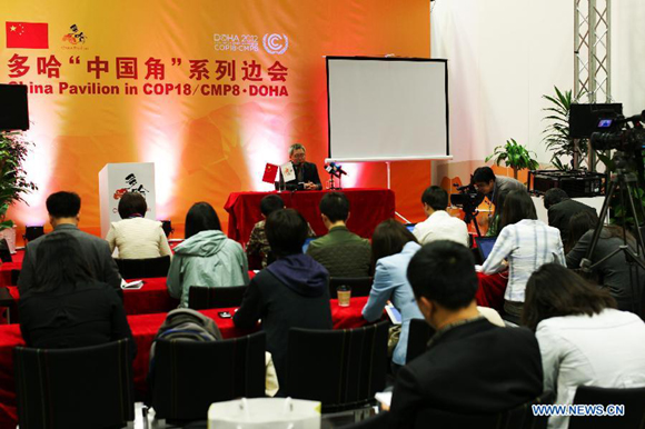 Su Wei (rear), deputy chief of the Chinese delegation to the Doha conference, talks during a media briefing on the progress of the first week's conference at the China Pavilion in Qatar National Convention Center (QNCC) in Doha, Qatar, Dec. 1, 2012.