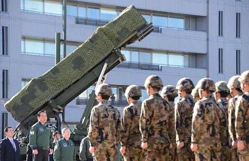 Japanese Prime Minister Yoshihiko Noda (2nd L) gives a speech as he addresses soldiers while in front of a Patriot Advanced Capability-3 (PAC-3) missile launcher at the Defence Ministry in Tokyo on December 7, 2012. Japan on December 7 issued the order to shoot down a North Korean rocket if it threatens the nation's territory, the top government official said. [Xinhua/AFP]