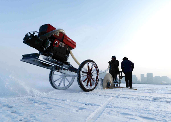 Workers cut ice on the Songhua River in preparation for the upcoming 29th Harbin International Ice and Snow Festival in Harbin, Northeast China's Heilongjiang province, Dec 8, 2012. [Photo/Xinhua]