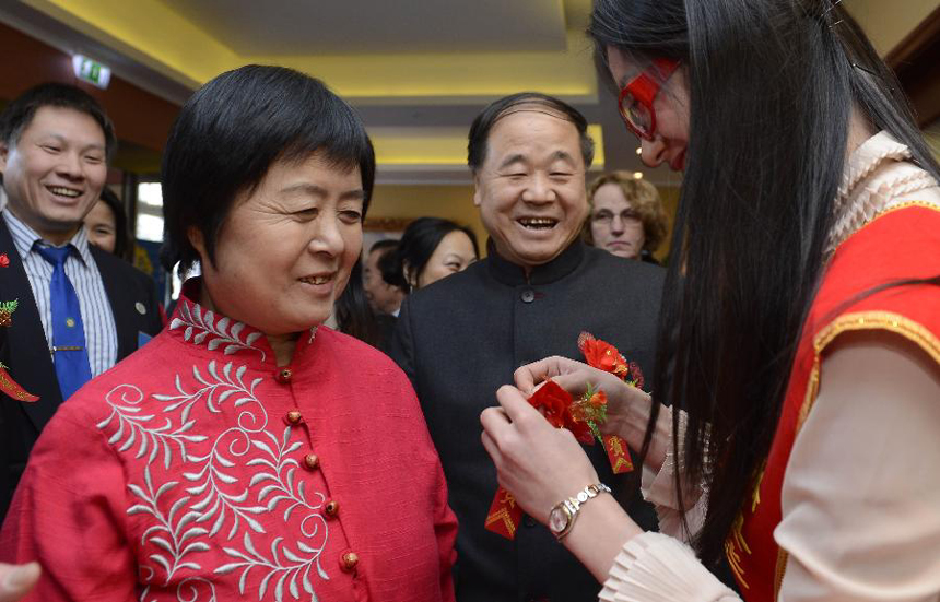 Chinese writer Mo Yan (2nd R), the 2012 Nobel Prize winner for literature, and his wife (2nd L) attend a reception by Chinese entrepreneurs in Stockholm, capital of Sweden, Dec. 8, 2012. 