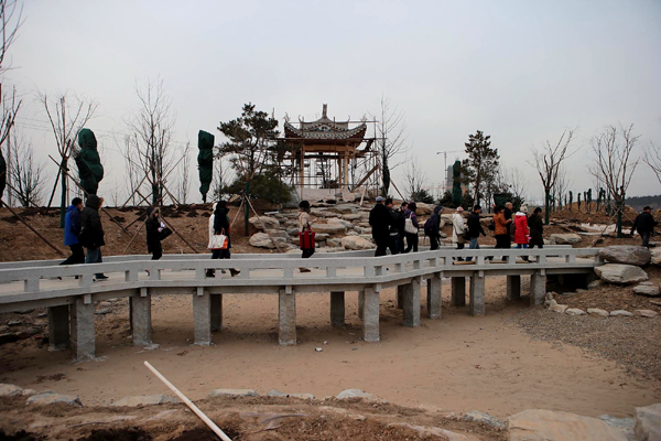 Visitors tour a construction site on Thursday at a park that will open alongside the ninth China International Garden Expo, which will be held in 2013 at Fengtai district in southwestern Beijing. [Photo/China Daily]