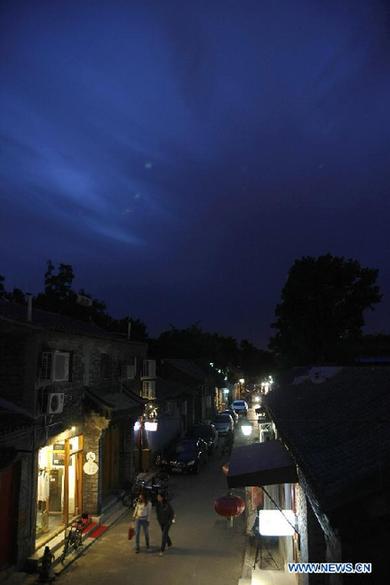 Visitors linger along the Wudaoying Hutong at night in Beijing, China, Sept. 9, 2011.