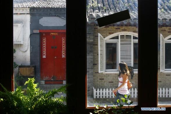 A tourist linger along the Wudaoying Hutong lined with Chinese and western-style houses in Beijing, China, Aug. 15, 2011.