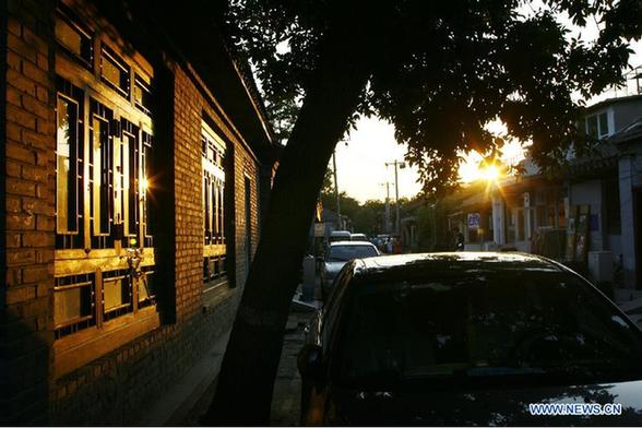 Photo taken on Aug. 16, 2011 shows the sunset in Wudaoying Hutong in Beijing, China.