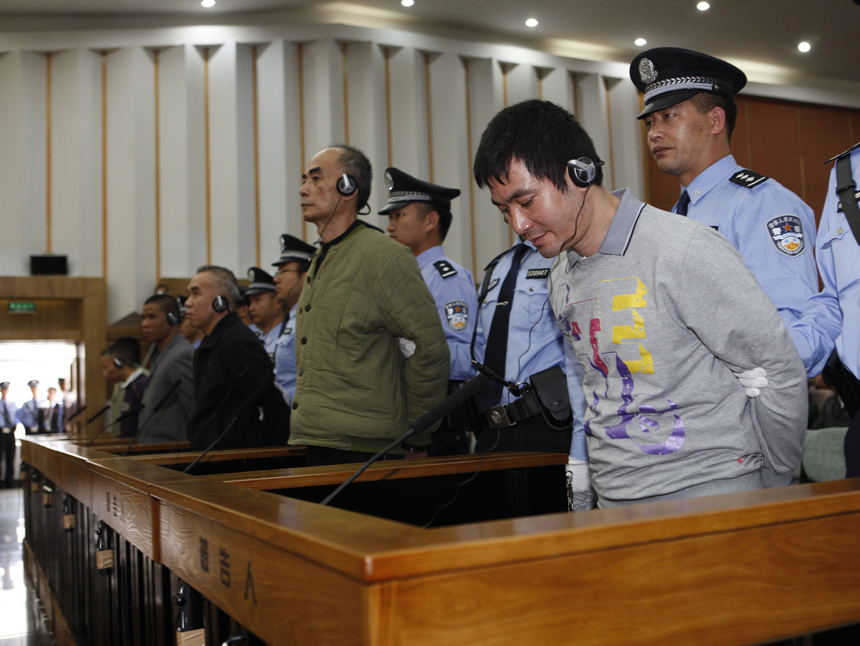 Naw Kham (1st R, front), principal suspect accused in the Mekong River murder case, and five accomplices hear their verdicts at court in Kunming, capital of southwest China's Yunnan Province, Nov. 6, 2012. Naw Kham was sentenced to death on Nov. 6. The 13 Chinese sailors were murdered after two cargo ships, the Hua Ping and Yu Xing 8, were hijacked on Oct. 5, 2011 on the Mekong River, an important waterway in Southeast Asia. 