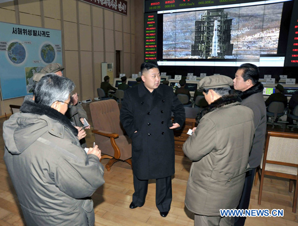 Photo released by Korean Central News Agency (KCNA) on Dec. 16, 2012 shows Kim Jong Un (C), top leader of the Democratic People's Republic of Korea (DPRK), congratulate recently on scientific workers of the second Kwangmyongsong-3 satellite launch project at Sohae Space Center in Cholsan County, North Phyongan Province, DPRK. 