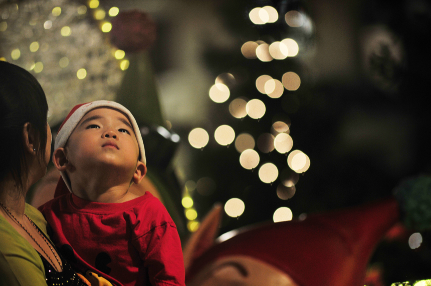 A child watches Christmas decorations in a street Singapore on Dec. 24, 2012. 