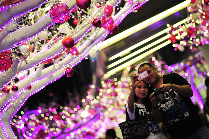 People go shopping in a street in Singapore on Dec. 24, 2012. 