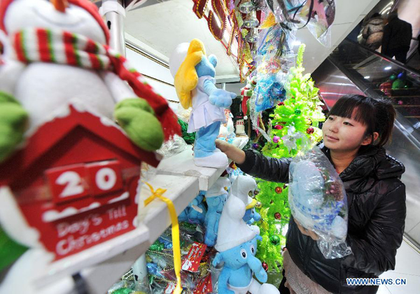A woman selects Christmas ornaments at a holiday decoration store in Yinchuan, capital of northwest China&apos;s Ningxia Hui Autonomous Region, Dec. 19, 2012. As Christmas is drawing near, shopping malls and decoration stores in Yinchuan start to sell related decoration articles. 