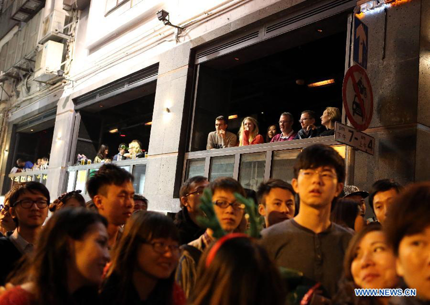 Visitors celebrate the Christmas at Lan Kwai Fong, a commercial area in Hong Kong, south China, early Dec. 25, 2012. 