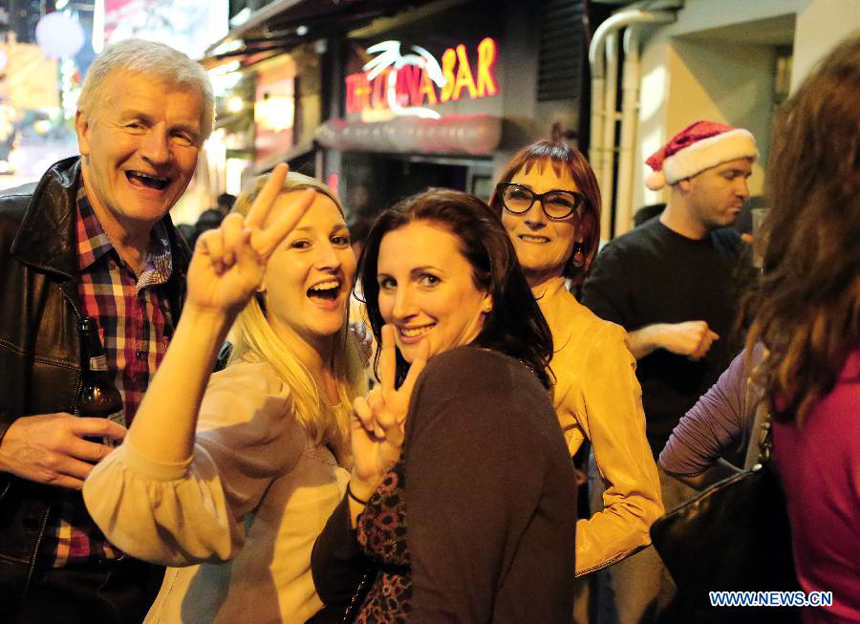 Foreign visitors celebrate the Christmas at Lan Kwai Fong, a commercial area in Hong Kong, south China, early Dec. 25, 2012.