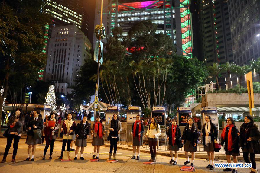 Citizens sing at the Statue Square in Hong Kong, south China, on Dec. 24, 2012.