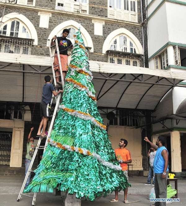 People prepare a Christmas tree outside a church to celebrate Christmas Day, in Mumbai, India, on Dec. 24, 2012. 
