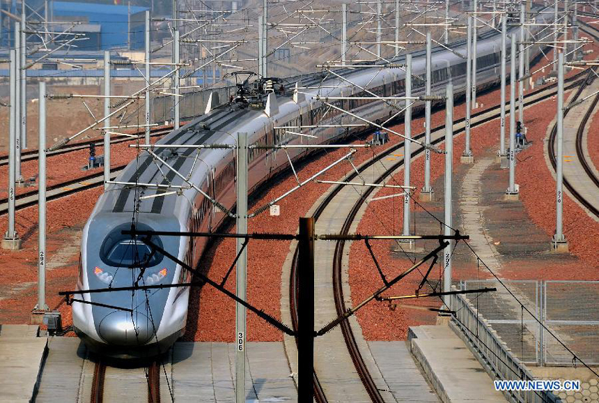 A bullet train from Guangzhou, capital of south China&apos;s Guandong Province, enters the Zhengzhou East Railway Station in Zhengzhou, capital of central China&apos;s Henan Province, Dec. 25, 2012. According to an announcement of the Ministry of Railways, the Beijing-Guangzhou high-speed railway, which links China&apos;s capital and Guangzhou, will open on Dec. 26 and is expected to cut the travel time to about 8 hours from the current 20-odd hours by traditional lines.