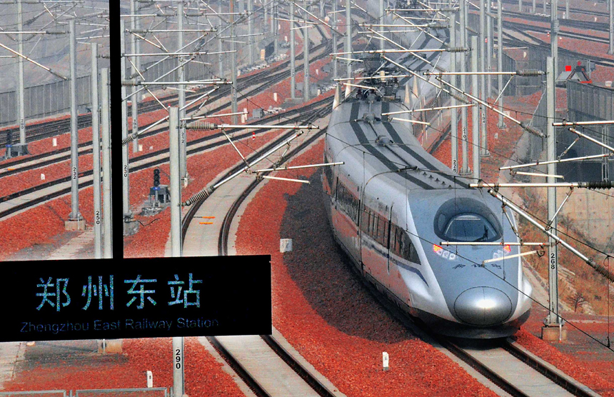 A bullet train from Beijing, capital of China, enters the Zhengzhou East Railway Station in Zhengzhou, capital of central China&apos;s Henan Province, Dec. 25, 2012. According to an announcement of the Ministry of Railways, the Beijing-Guangzhou high-speed railway, which links Beijing and the capital of south China&apos;s Guangdong Province, will open on Dec. 26 and is expected to cut the travel time to about 8 hours from the current 20-odd hours by traditional lines.