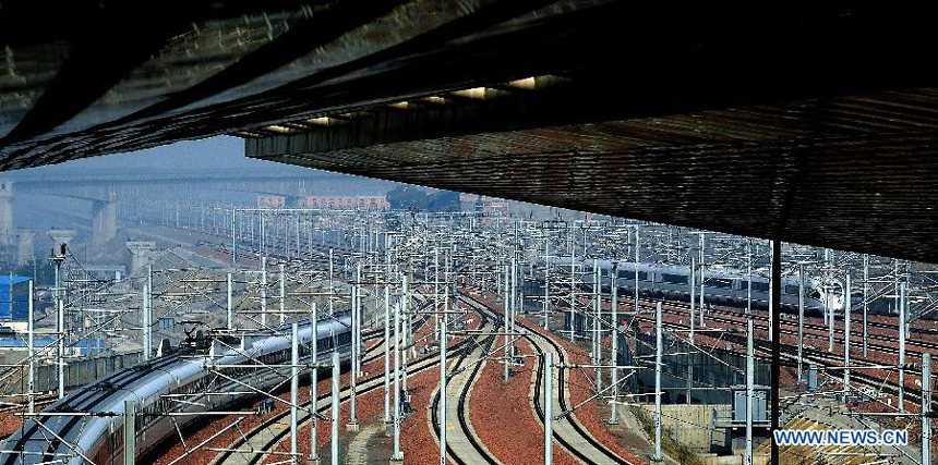 Bullet trains are seen the Zhengzhou East Railway Station in Zhengzhou, capital of central China&apos;s Henan Province, Dec. 25, 2012. According to an announcement of the Ministry of Railways, the Beijing-Guangzhou high-speed railway, which links China&apos;s capital and the capital of south China&apos;s Guangdong Province, will open on Dec. 26 and is expected to cut the travel time to about 8 hours from the current 20-odd hours by traditional lines.