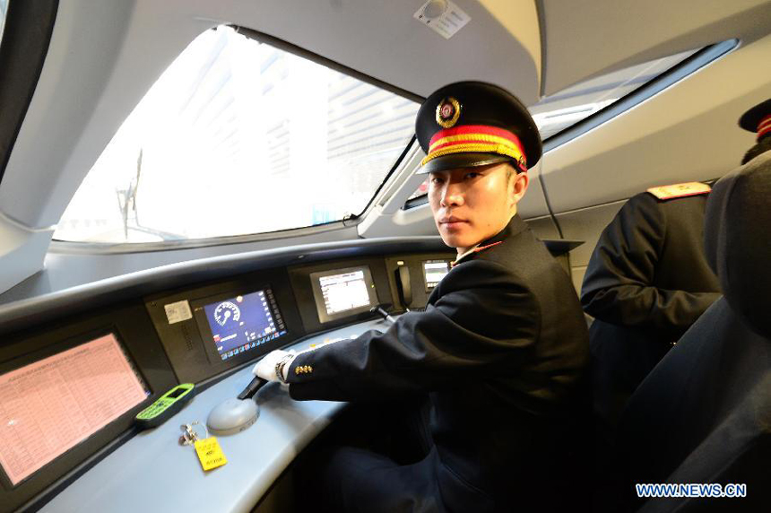 Driver Zhang Xi prepares to operate bullet train G801 to leave the Beijing West Railway Station in Beijing, capital of China, for Guangzhou, capital of south China's Guangdong Province, Dec. 26, 2012. 