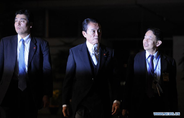 Former Prime Minister Taro Aso (C), vice prime minister, financial minister and financial services minister, arrives at the prime minister&apos;s official residence in Tokyo, Japan, Dec. 26, 2012. Japan&apos;s new Chief Cabinet Secretary Yoshihide Suga on Wednesday announced members of a new cabinet led by Prime Minister Shinzo Abe, who just claimed the post in a special session of the Diet.