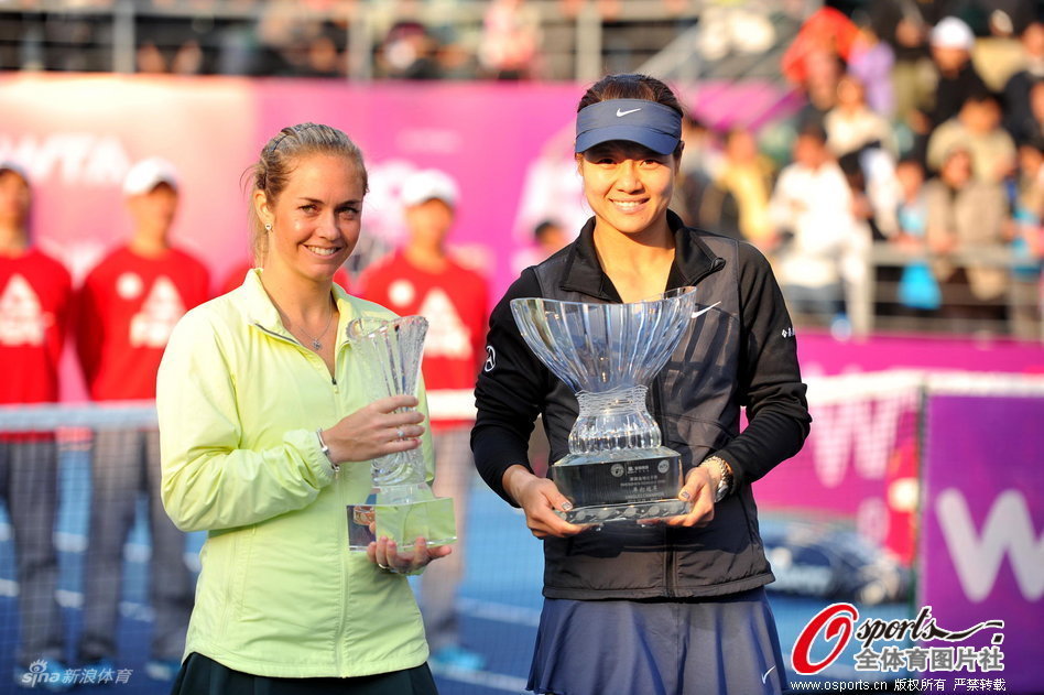 Li Na of China returns and Klara Zakopalova of the Czech Republic pose with trophies after Shenzhen Open final on Jan.5, 2012.