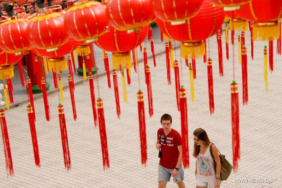 Visitors walk pass red lanterns in Thean Hou Temple in Kuala Lumpur, capital of Malaysia, on Jan. 7, 2013. Red lanterns are decorated to greet the upcoming Chinese Lunar New Year, Year of the Snake. 