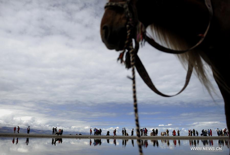 File photo taken on Aug. 7, 2012 shows tourists visiting Lake Namtso in southwest China's Tibet Autonomous Region. 