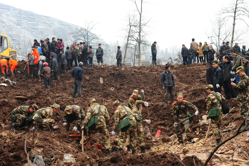 Rescuers work at the landslide site at Gaopo Village of Zhenxiong County, southwest China's Yunnan Province, Jan. 11, 2013. More than 10 residential houses with over 40 people were buried after a landslide happened at the village early Friday morning, according to local officials.